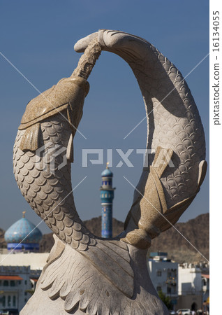Minaret seen through a double dolphin sculpture 16134055