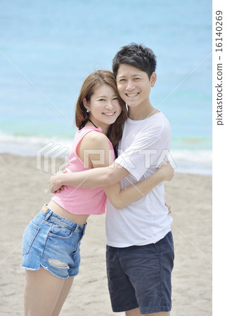A couple embracing at the sandy beach A couple embracing at the sandy beach 16140269