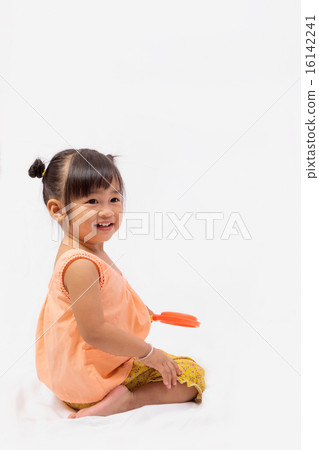 Asian girl with Thai traditional dress playing  16142241