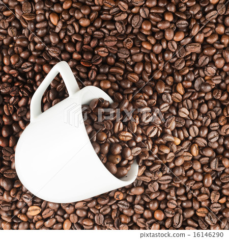 Coffee beans spilled out of ceramic cup 16146290