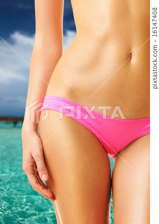 Woman on beautiful beach with jetty 16147408