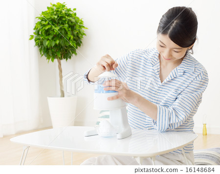 A woman shaving ice A woman shaving ice 16148684