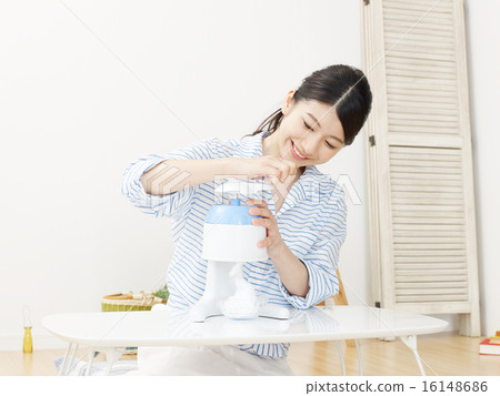A woman shaving ice A woman shaving ice 16148686