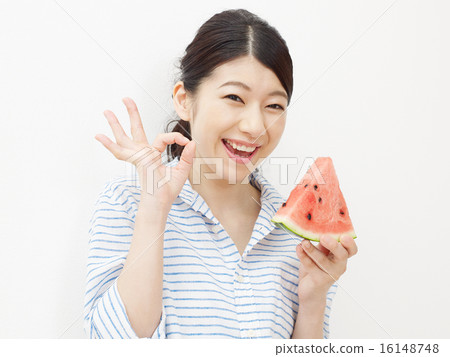 Woman eating watermelon OK sign Woman eating watermelon OK sign 16148748