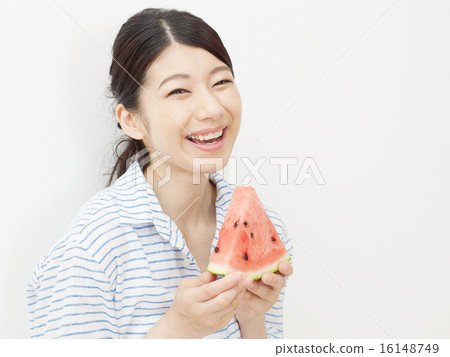 A woman eating a watermelon A woman eating a watermelon 16148749