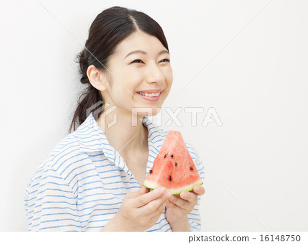 A woman eating a watermelon A woman eating a watermelon 16148750