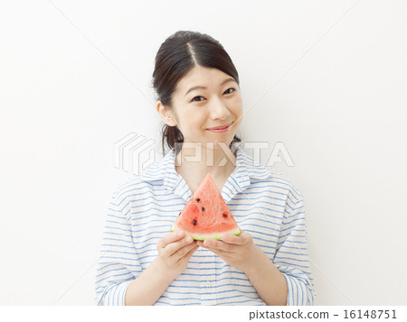 A woman eating a watermelon A woman eating a watermelon 16148751