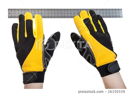 builder hands in safety gloves with ruler 16150339