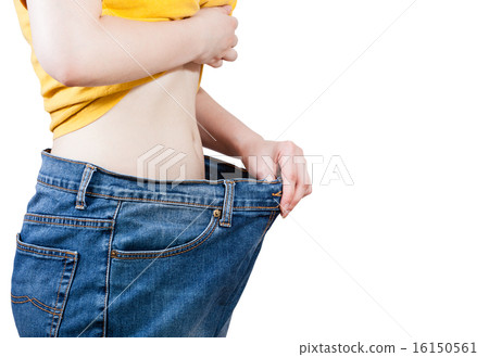 slim girl trying on large size old jeans isolated slim girl trying on large size old jeans isolated 16150561