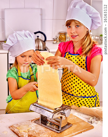 Kids girl making homemade pasta at kitchen. Kids girl making homemade pasta at kitchen. 16163112