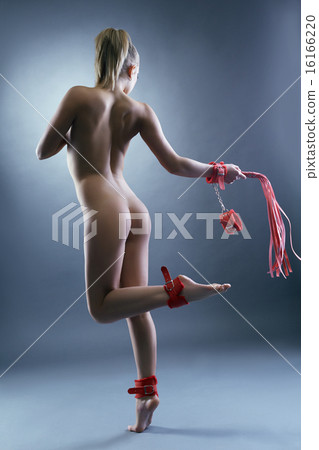 Rear view of naked slim woman with BDSM toys 16166220