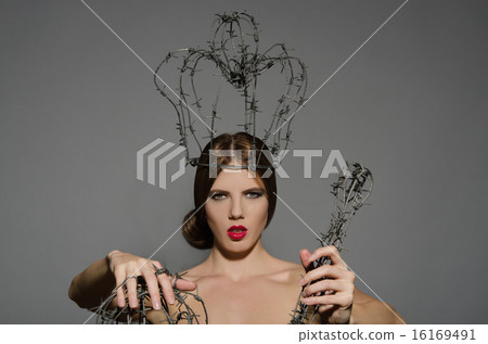 Woman with symbols power of barbed wire 16169491