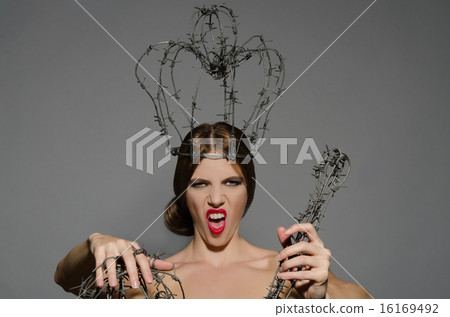 Young lady with metal symbols of power shouts 16169492