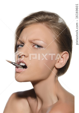 Portrait of woman with bullet in mouth Portrait of woman with bullet in mouth 16169601