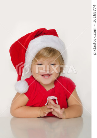 girl in costume of Santa at table and smiling girl in costume of Santa at table and smiling 16169774