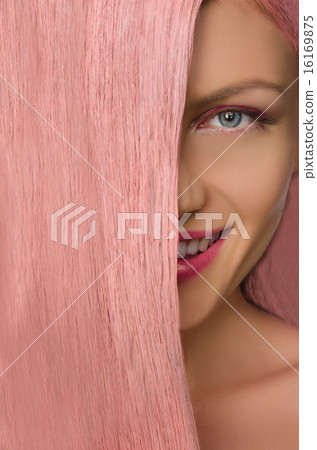 woman with pink hair looking at camera woman with pink hair looking at camera 16169875