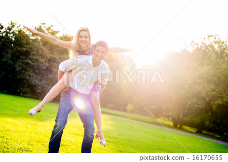 Man carrying girl piggyback in summer Man carrying girl piggyback in summer 16170655
