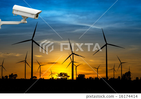 Stock Photo: CCTV security camera with Wind turbine power generator with suns