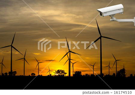 Stock Photo: CCTV security camera with Wind turbine power generator with suns