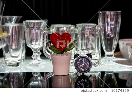 Heart and clock with various glasses on black background Heart and clock with various glasses on black background 16174539