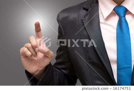 Businessman pointing or touching on gray background Businessman pointing or touching on gray background 16174751