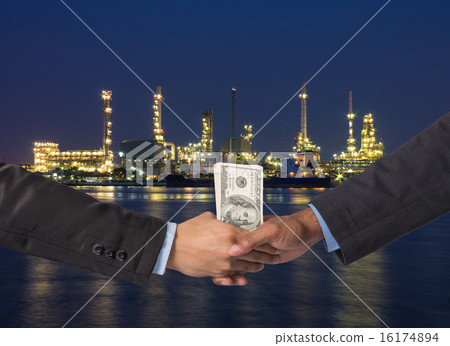 Hand shake between a businessman with dollar money on Petrochemi 16174894