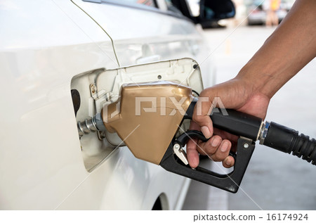 Men hold Fuel nozzle to add fuel in car at filling station Men hold Fuel nozzle to add fuel in car at filling station 16174924