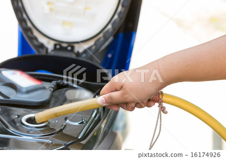 hold traditional rubber tube to add fuel in motorcycle hold traditional rubber tube to add fuel in motorcycle 16174926