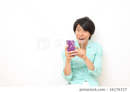 Male in twenties using smartphone 16176727