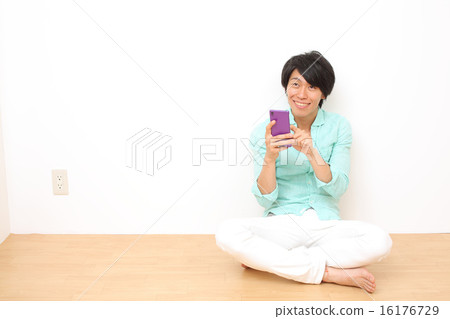 Male in twenties using smartphone 16176729