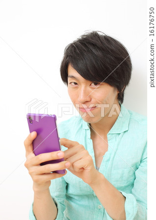 Male in twenties using smartphone 16176750