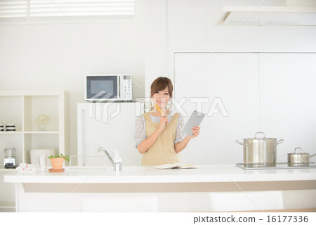 Girls using the iPad in the kitchen Girls using the iPad in the kitchen 16177336