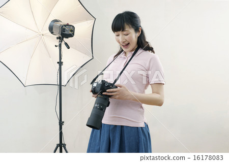 Studio, smiling female photographer 16178083