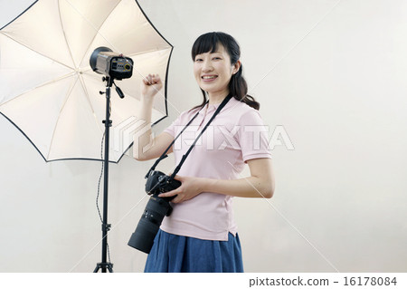 Studio, smiling female photographer 16178084