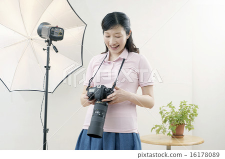 Studio, smiling female photographer 16178089