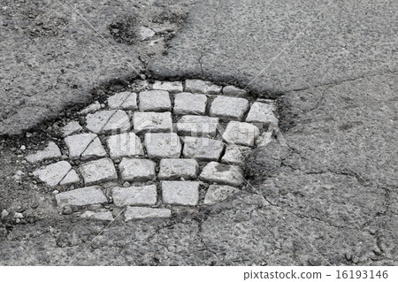 Pothole with old gray stone pavement 16193146