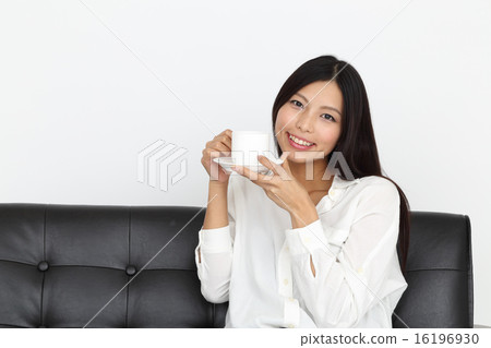 A young lady with a cup of coffee A young lady with a cup of coffee 16196930