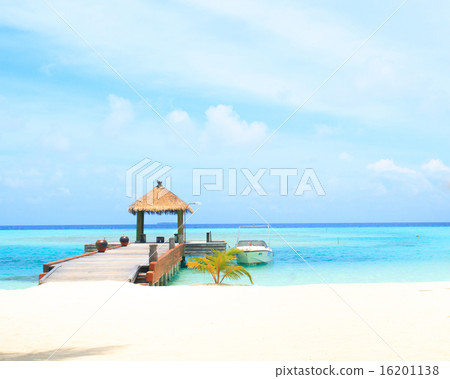 Overwater villas in blue tropical lagoon Overwater villas in blue tropical lagoon 16201138