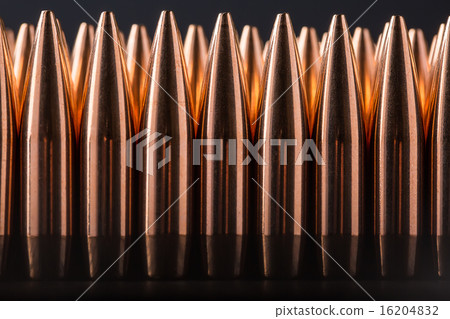Macro shot of copper bullets that are in many row Macro shot of copper bullets that are in many row 16204832