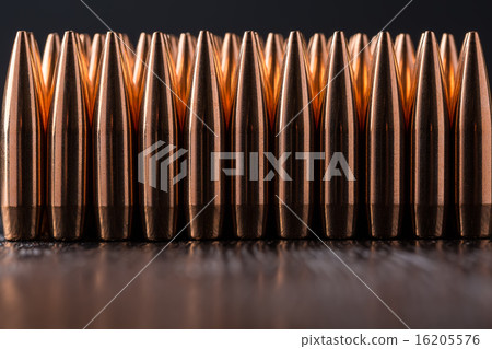 Macro shot of copper bullets that are in many row Macro shot of copper bullets that are in many row 16205576