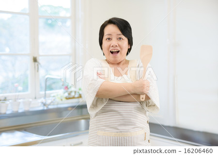 Pose collection of middle-aged women standing in the kitchen 16206460