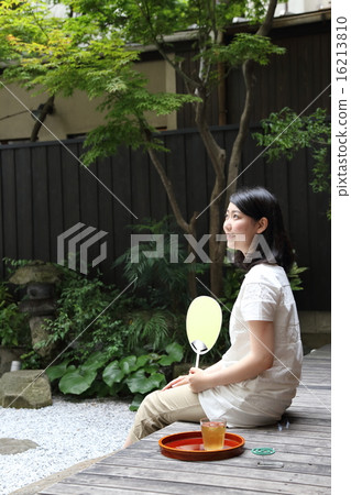 A woman sitting on the verge A woman sitting on the verge 16213810