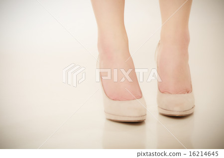 Closeup of female feet in beige high heels. Closeup of female feet in beige high heels. 16214645