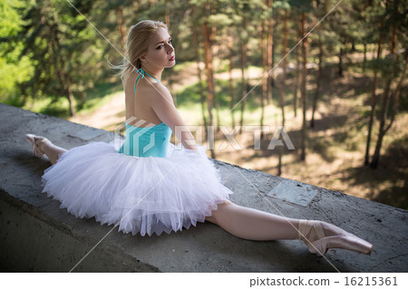 Graceful ballerina in white tutu sitting on the splits 16215361
