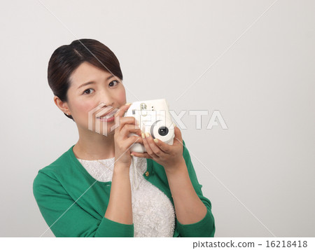 A woman with an instant camera A woman with an instant camera 16218418