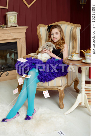 Young girl at the image of Alice in Wonderland Young girl at the image of Alice in Wonderland 16218898