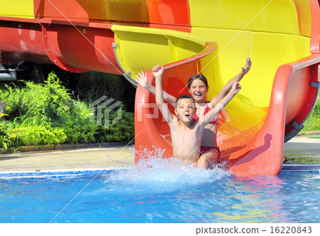 children sliding down a water slide 16220843
