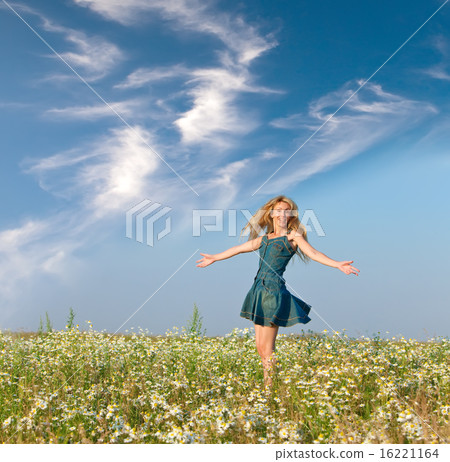 young woman jumps in the field of camomiles young woman jumps in the field of camomiles 16221164