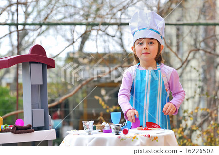 Little girl having fun playing cooking 16226502