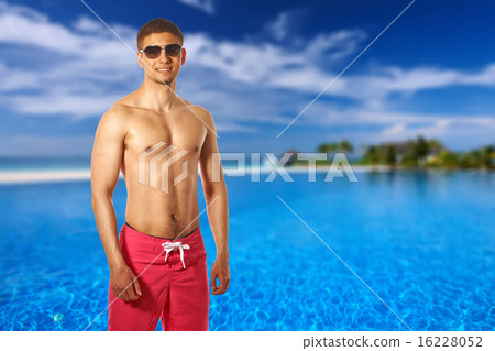 Man at tropical swimming pool 16228052